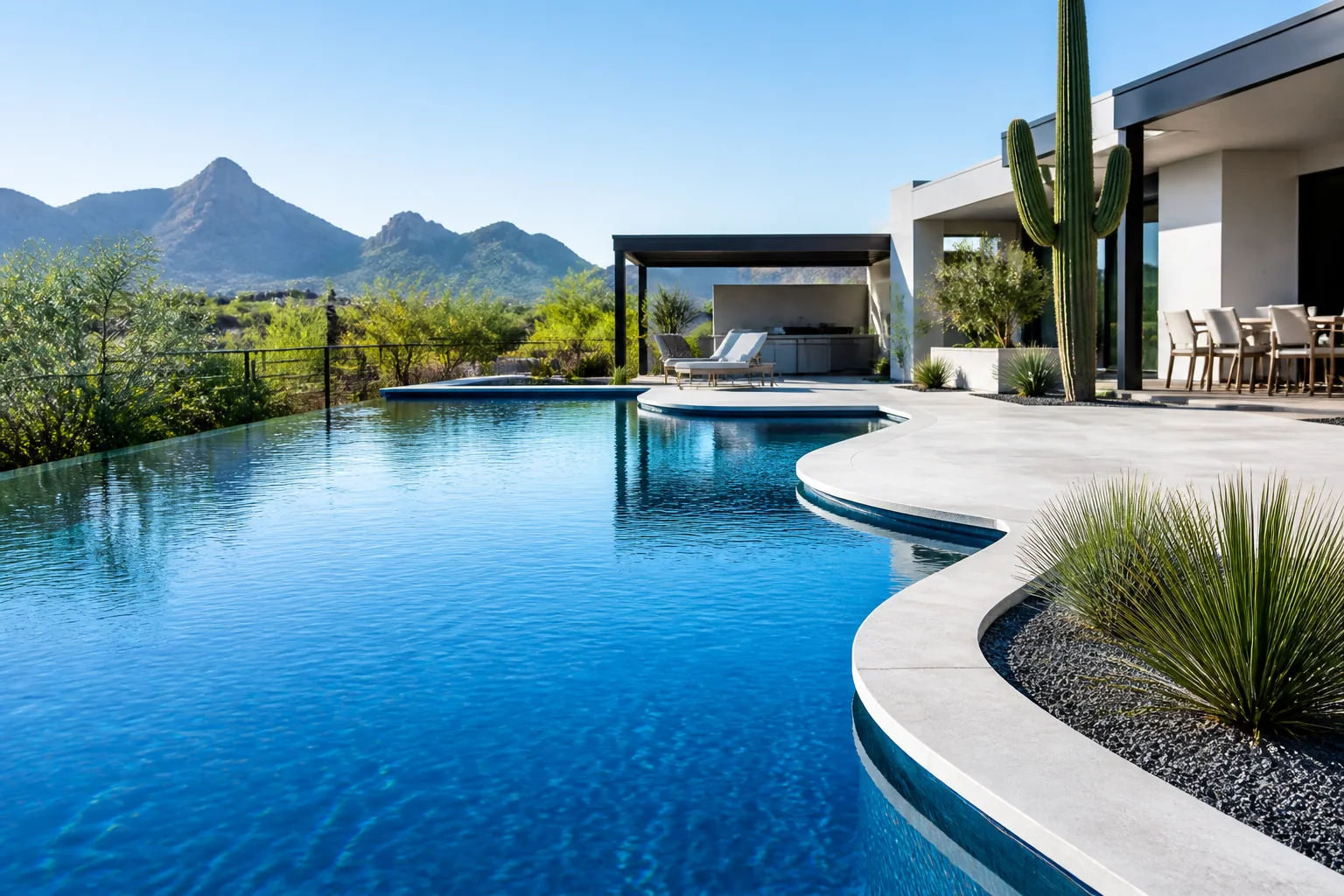 Cobalt pool beside a modern Scottsdale home with desert mountains beyond